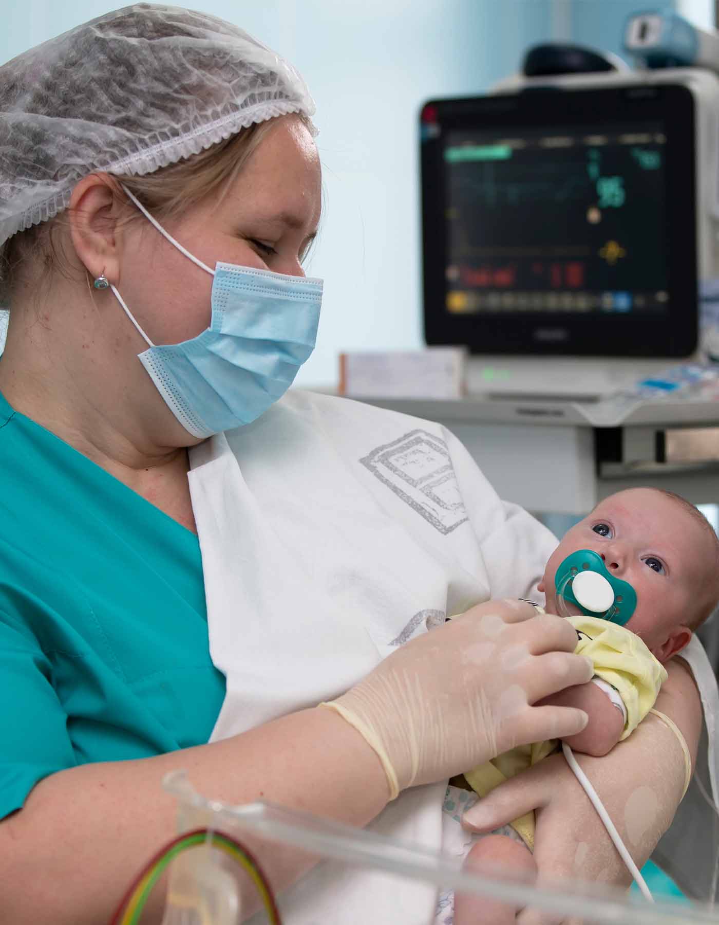 Neonatal nurse practitioner taking care of a newborn