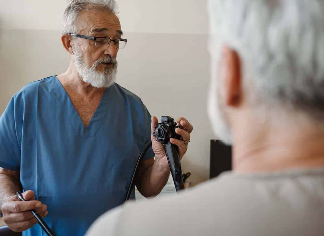 Gastroenterologist explaining gastroscopy procedure on patient