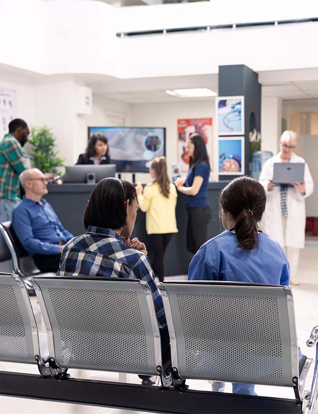 Hospital staff assisting patients in emergency waiting room