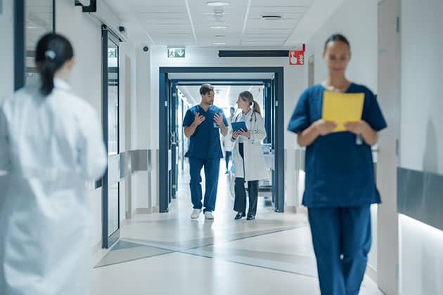 Healthcare Professionals Walking to Their Examination Rooms