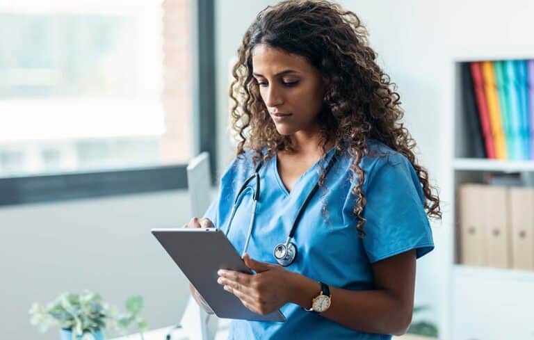 Nurse checking LPN salary info in NJ in her tablet