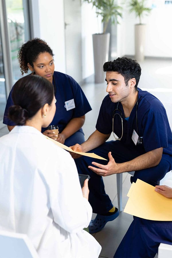 nurse practitioner giving patient's information to physician