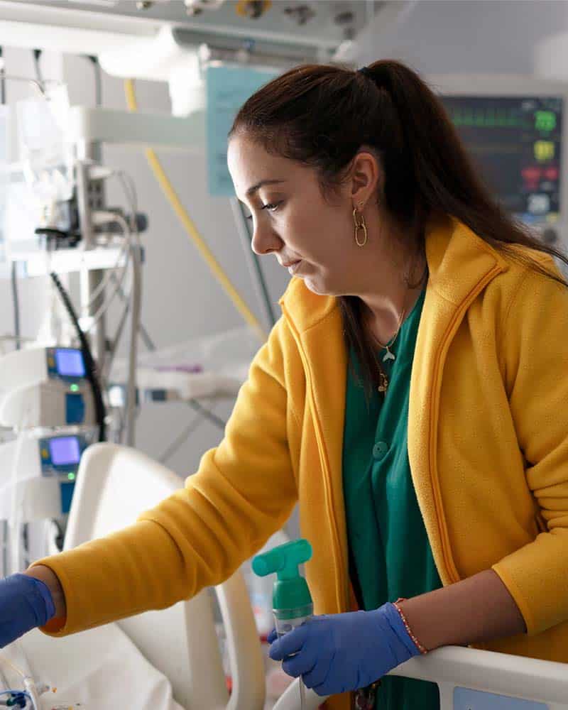 Nurse checking on critical patient