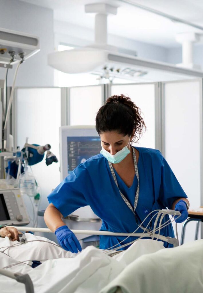 Nurse practitioner checking patient in icu