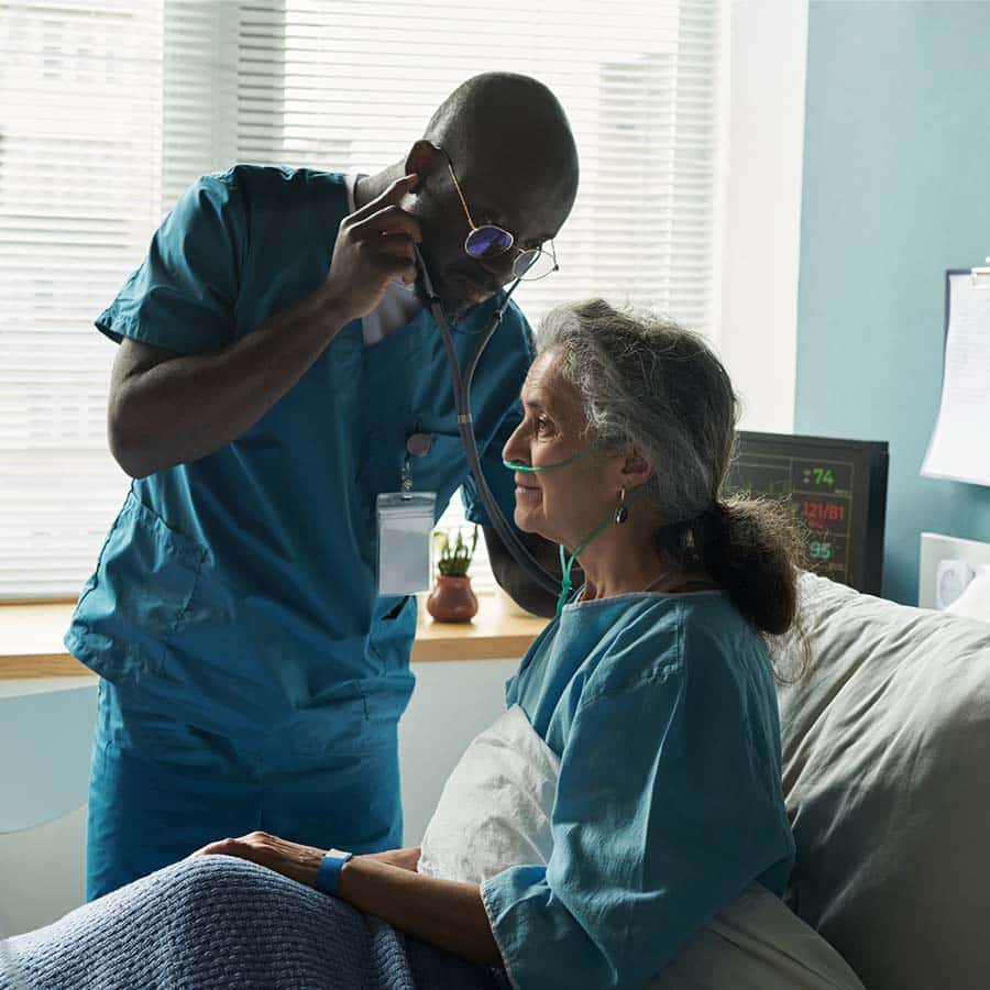geriatric male nurse checking patient
